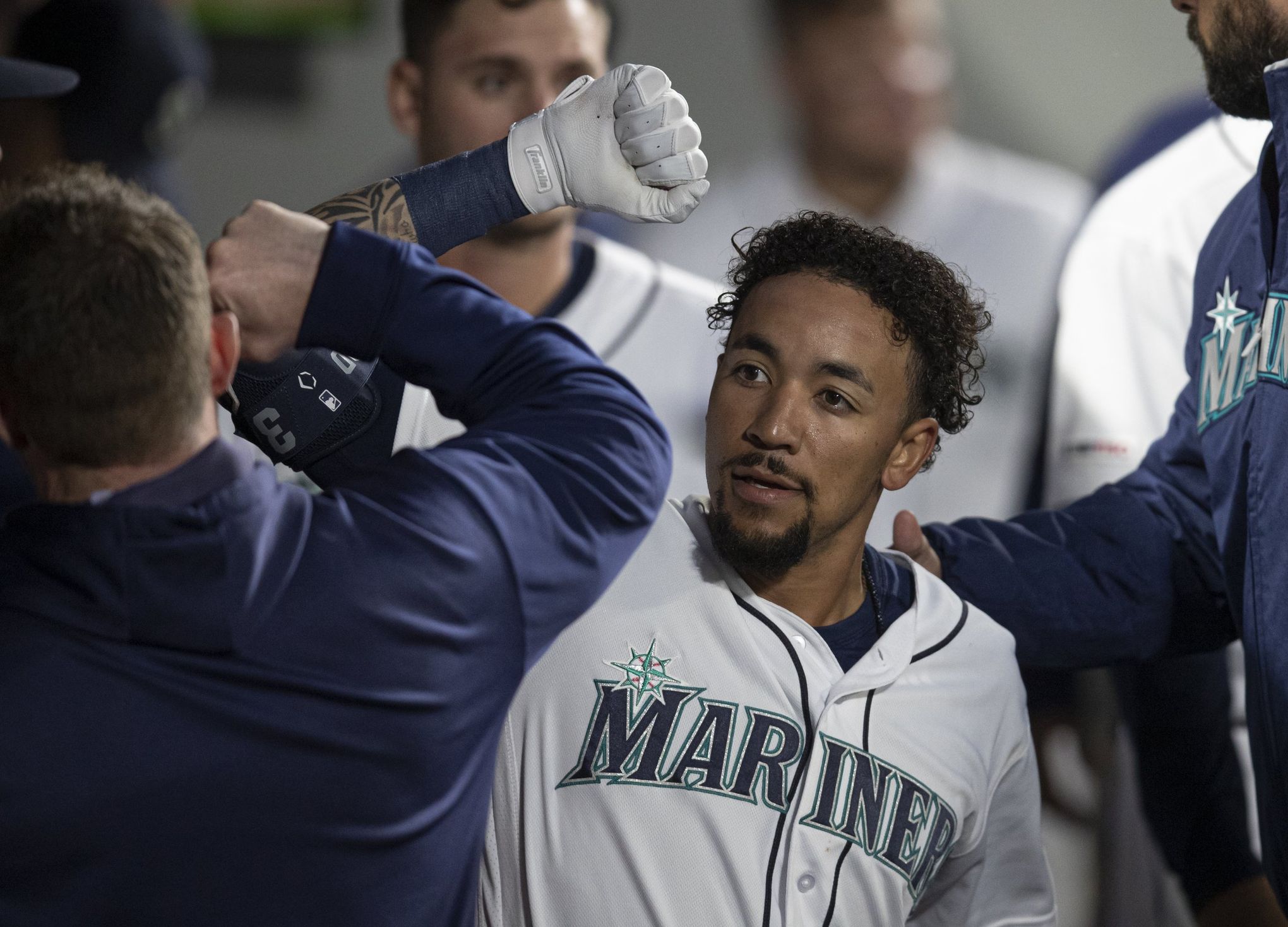 Seattle Mariners' Dee Gordon celebrates in the dugout after a home