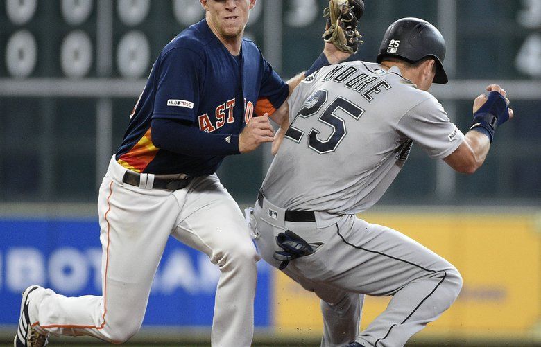 Houston Astros shortstop Myles Straw, left, tags out Seattle Mariners’ Dylan Moore during a steal-attempt during the fifth inning of a baseball game, Sunday, June 30, 2019, in Houston. (AP Photo/Eric Christian Smith) TXES111 TXES111