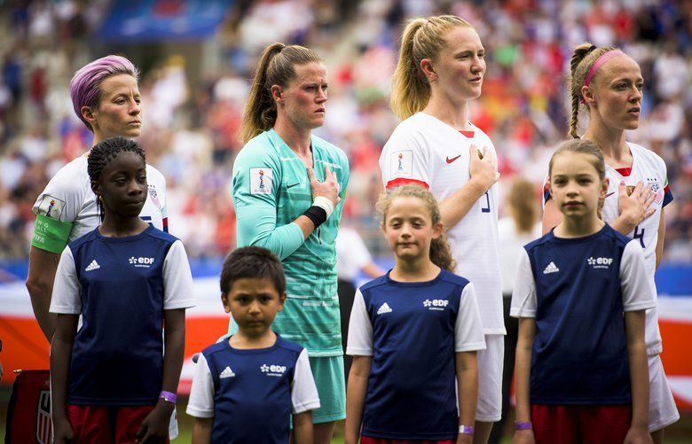 From left: Megan Rapinoe, Alyssa Naeher, Samantha Mewis and Becky Sauerbrunn of the U.S. team listen to the national anthem before their Women’s World Cup round of 16 match against Spain at Stade Auguste-Delaune in Reims, France, June 24, 2019. The U.S. won 2-1 to advance into the quarterfinals, where they will face France. (Pete Kiehart/The New York Times)  XNYT72 XNYT72