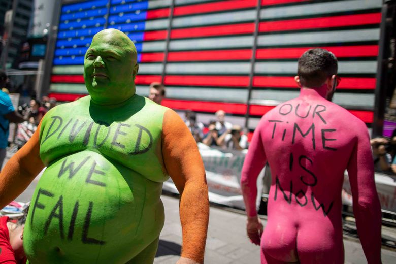 Protesters strip, get painted in Times Square | The Seattle Times