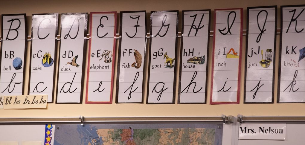 Hamlin Robinson School fourth grade teacher Kay Nelson displays proper use of cursive penmanship in her classroom. (Mike Siegel / The Seattle Times)