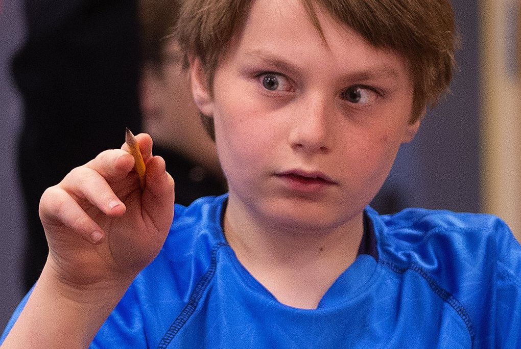 Hamlin Robinson School fourth grader Michael Parton writes in the air as part of the process of learning to spell and write in cursive. (Mike Siegel / The Seattle Times)