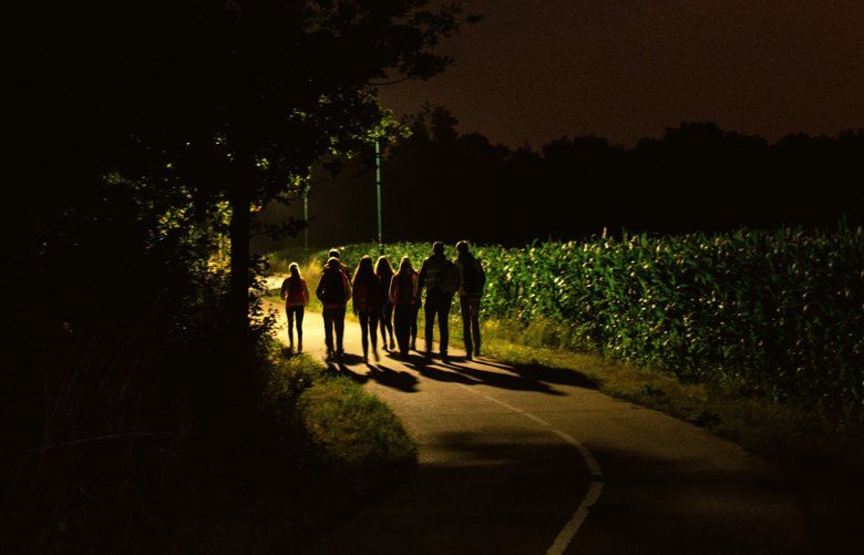 A group of children participate in a Dutch tradition known as “dropping,” where groups of children are deposited in a forest and have to find their way back to base, near Eindhoven, Netherlands, July 13, 2019. The tradition is meant to be challenging while distilling Dutch principles, such as problem solving, into extreme form. (Dmitry Kostyukov/The New York Times) XNYT103