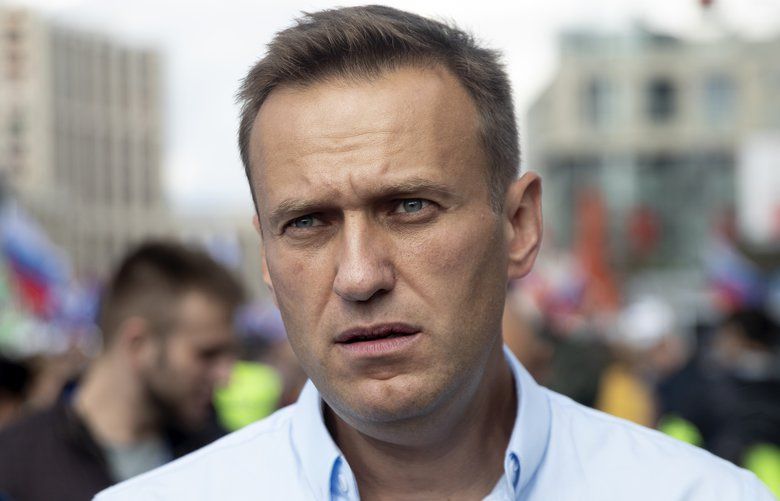 FILE – In this Saturday, July 20, 2019, file photo, Russian opposition leader Alexei Navalny attends a protest in Moscow, Russia. Navalny remained hospitalized for a second day on Monday, July 29, 2019, after his physician said he may have been poisoned. Details about Navalny’s condition were scarce after Navalny was rushed to a hospital Sunday from a detention facility where he was serving a 30-day sentence for calling an unsanctioned protest. (AP Photo/Pavel Golovkin, File) XAZ102 XAZ102