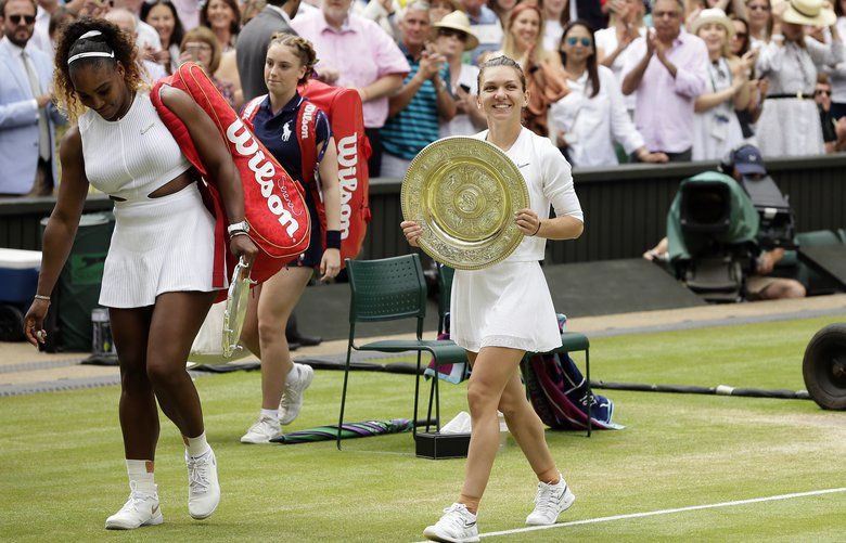 Romania’s Simona Halep walks away with her trophy after defeating United States’ Serena Williams, left, in the women’s singles final match on day twelve of the Wimbledon Tennis Championships in London, Saturday, July 13, 2019. (AP Photo/Tim Ireland) XAF141 XAF141