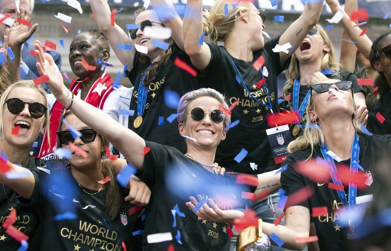 Megan Rapinoe, center, is joined by her teammates on the U.S. women’s national soccer team during a celebratory rally at City Hall following a ticker-tape parade in New York on Wednesday, July 10, 2019. The team, which defeated the Netherlands, 2-0, on Sunday in the World Cup final, traversed the Canyon of Heroes, a stretch of Broadway from Battery Park to City Hall. (Calla Kessler/The New York Times)  XNYT98 XNYT98