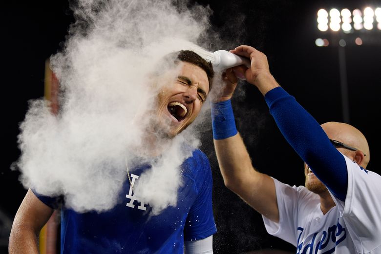 Matt Beaty of the Los Angeles Dodgers is covered by baby powder by