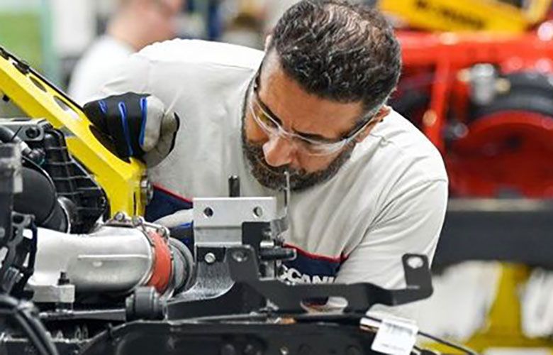 Employees work on the production line at the Scania AB cargo truck factory in Sodertalje, Sweden. (Bloomberg)