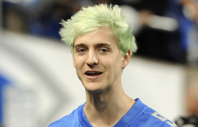 FILE – In this Sept. 10, 2018, file photo, Fortnite superstar Tyler “Ninja” Blevins watches before an NFL football game between the Detroit Lions and New York Jets in Detroit. Blevins is leaving Twitch and taking his video game live streams to Microsoft’s Mixer platform, a stunning transition that could have wide-ranging consequences for the rapidly growing industry. Blevins announced his move Thursday, Aug. 1, 2019, ending a hugely profitable partnership with Twitch, a live streaming giant owned by Amazon. (AP Photo/Jose Juarez, File) NYDD207 NYDD207
