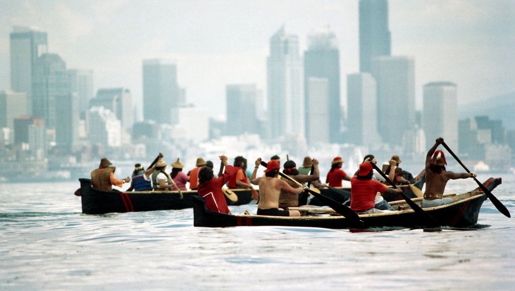 1989: Nearing the end of their historic 170-mile journey, Quileute and Hoh canoes are paddled across Elliott Bay to meet other canoe families at Alki during Washington centennial celebration. (Alan Berner / Seattle Times)