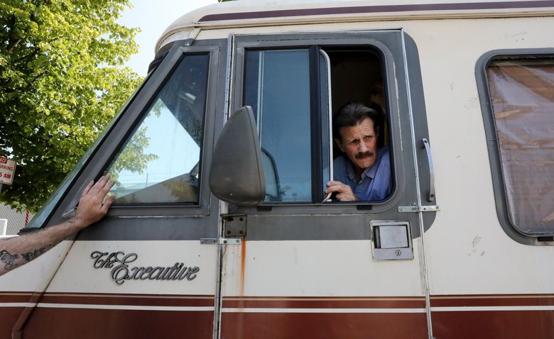 Richard Winn bought this 1984 “Executive” model RV, now parked in Ballard, for $275 at auction. Winn says he has been in the “vehicle ranching” business but says he no longer requires people to pay him to stay in his RVs. 
(Alan Berner / The Seattle Times)