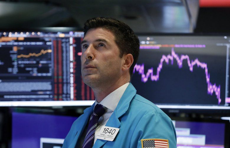 Trader Thomas McArdle works on the floor of the New York Stock Exchange, Wednesday, Aug. 14, 2019. The Dow Jones Industrial Average sank 800 points after the bond market flashed a warning sign about a possible recession for the first time since 2007. (AP Photo/Richard Drew) NYRD118 NYRD118