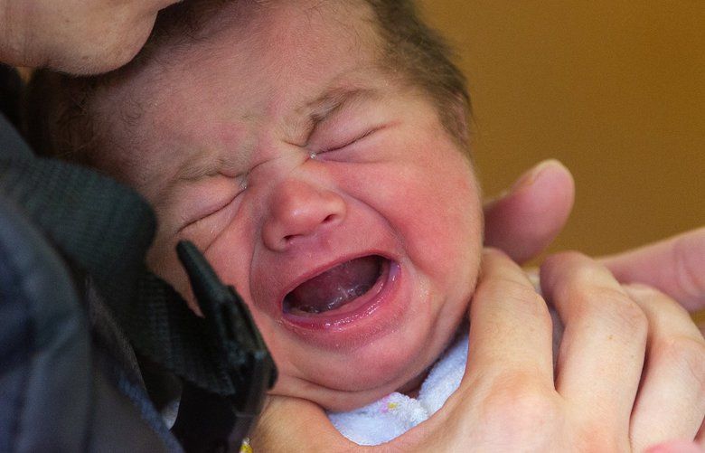 A woman holds her 15-day-old son at Evergreen Recovery Center in Everett where babies who suffer withdrawal after being born get help as the opioids withdraw from their bodies.
Photographed on June 27, 2019. 210703 210703