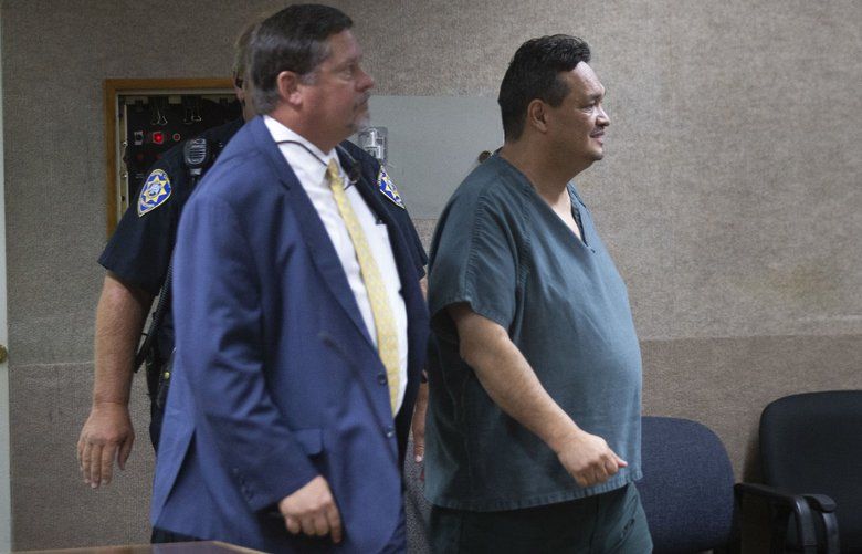 Former Wapato City Administrator Juan Orozco, right, walks into court for a preliminary appearance on Wednesday, Aug. 14, 2019 at Yakima County Department of Corrections in Yakima, Wash. (Evan Abell, Yakima Herald-Republic)