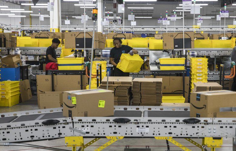 FILE — Workers at an Amazon fulfillment center in Staten Island, May 15, 2019. Some of Amazon’s warehouse employees work as social media ambassadors, responding to critical tweets about the e-commerce giant’s punishing working conditions. (Hiroko Masuike/The New York Times) XNYT139 XNYT139