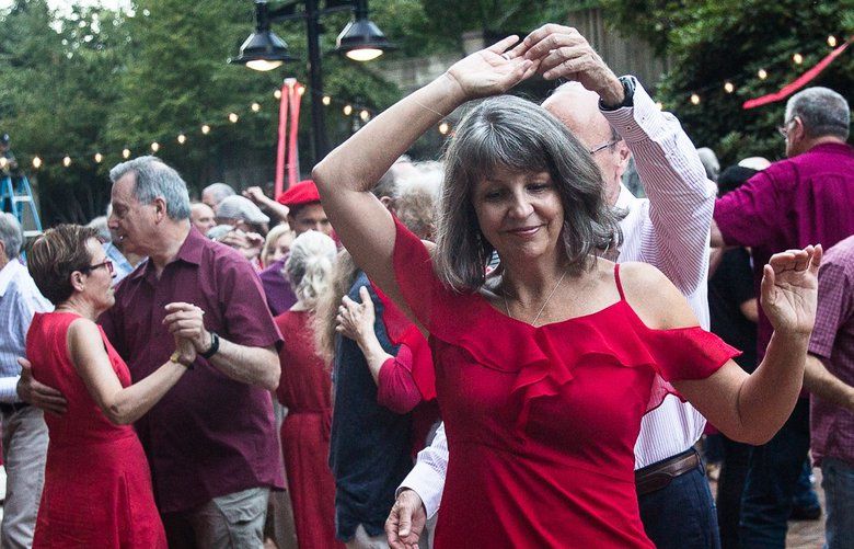 Cissy Adams is spun by Bob Thome during Dancing till’ Dusk on Thursday, August 22. Taking place in a different Seattle park each week, Dancing Till Dusk begins with an hour lesson and then live music and an open dance floor. 211290 . LO