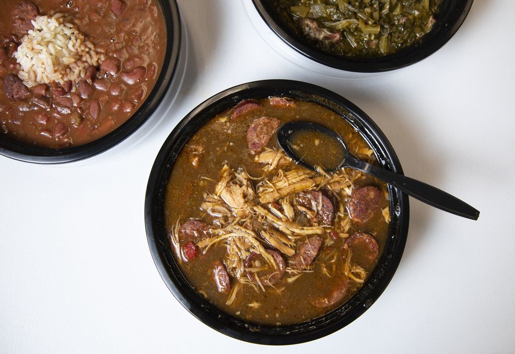 Altha’s Louisiana Cajun Seasoning in Kent dishes up, at center clockwise, chicken and sausage gumbo, red beans and rice, and collard greens. (Ellen M. Banner / The Seattle Times)