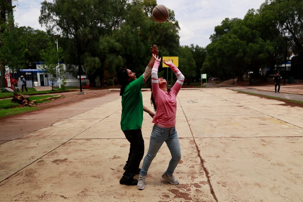 Chavo Eudave de la Torre plays basketball with his daughter Arianna at a Zacatecas park. On days he works, the two often play a game of basketball and eat at a nearby Little Caesars. (Erika Schultz / The Seattle Times)
