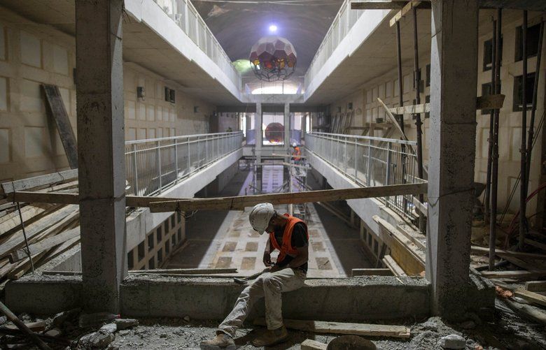 In this Sunday, Aug. 18, 2019 photo, a laborer works at the construction site of a massive underground cemetery in Jerusalem. Under a mountain on the outskirts of Jerusalem, workers are completing three years of labor on a massive subterranean necropolis comprised of a mile (1.5 kilometers) of tunnels with sepulchers for interring the dead. (AP Photo/Oded Balilty) XOB104 XOB104