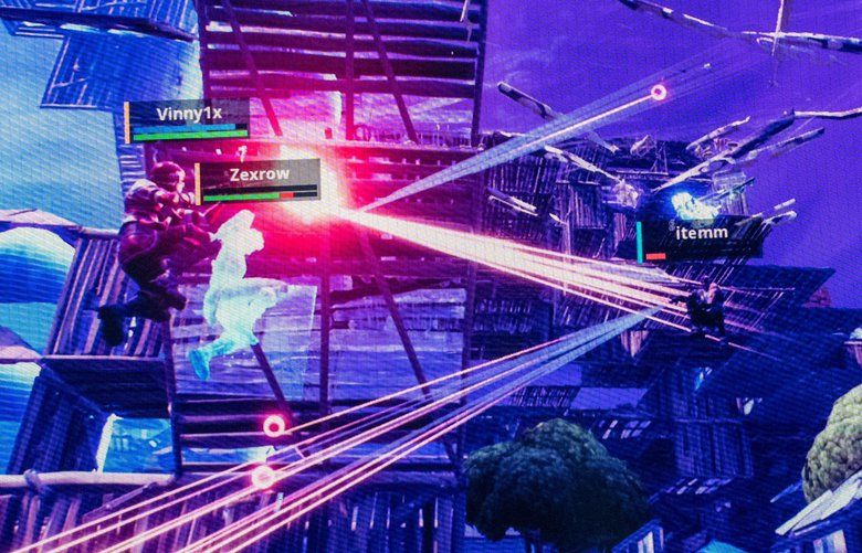 **EMBARGO: No electronic distribution, Web posting or street sales before TUESDAY 3:00 A.M. ET AUG. 27, 2019. No exceptions for any reasons. EMBARGO set by source.** FILE — A video feed of competitors playing Fortnite is displayed on a screen at the Fortnite World Cup at Arthur Ashe Stadium in New York, July 27, 2019. Epic Games, which introduced an online platform for buying PC games in December, wants to change the way people buy video games, but it faces the dominance of Steam, the primary destination for online game purchases. (Brian Finke/The New York Times) XNYT206 XNYT206