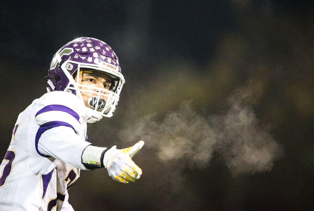 Lake Stevens’ Kasen Kinchen gestures to his team as the Woodinville Falcons take on the Lake Stevens Vikings during the state football semifinals last year. (Rebekah Welch / The Seattle Times)