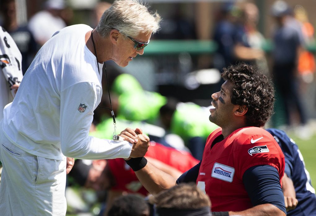 Pete Carroll and Russell Wilson talk before Saturday’s practice at Pop Keeney Stadium in Bothell.The Seattle Seahawks held a public practice at Pop Keeney Stadium in Bothell, WA, Saturday August 3, 2019. (Dean Rutz / The Seattle Times)