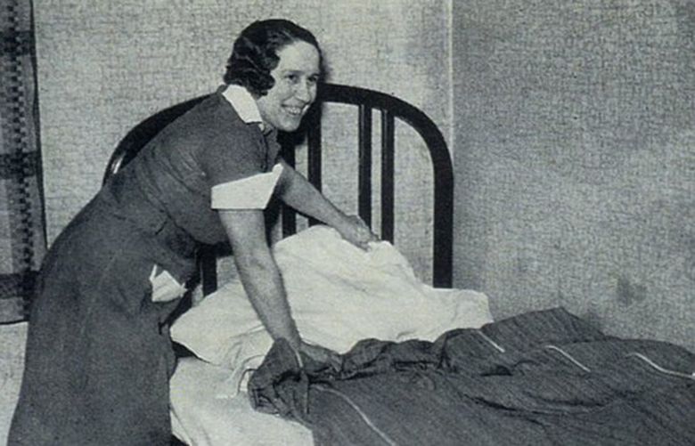 Novemver 21, 1936: Elsie Parrish, a maid at the Hotel Cascadian, makes a bed.