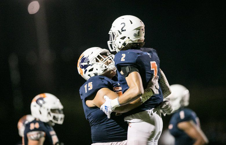 Eastside Catholic’s Sam Adams (2) and Ayden Hector embrace after Adams scored a touchdown as the Crusaders battle the Garfield Bulldogs at Eastside Catholic High School on Friday, September 28, 2018. 207894