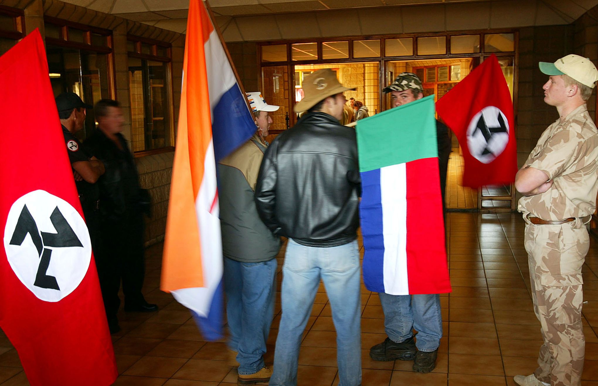 White South African man holds up a flag for the Afrikaner