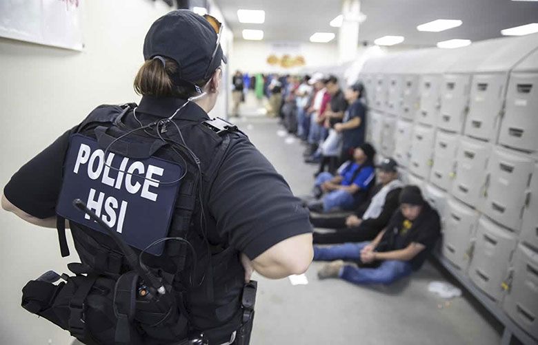 Homeland Security ICE enforcement officers detain workers at a poultry processing plant on Aug. 7, 2019 in Jackson, Miss. U.S. immigration officers raided several Mississippi food processing plants, detaining 680 undocumented workers. (ICE/Zuma Press via TNS)