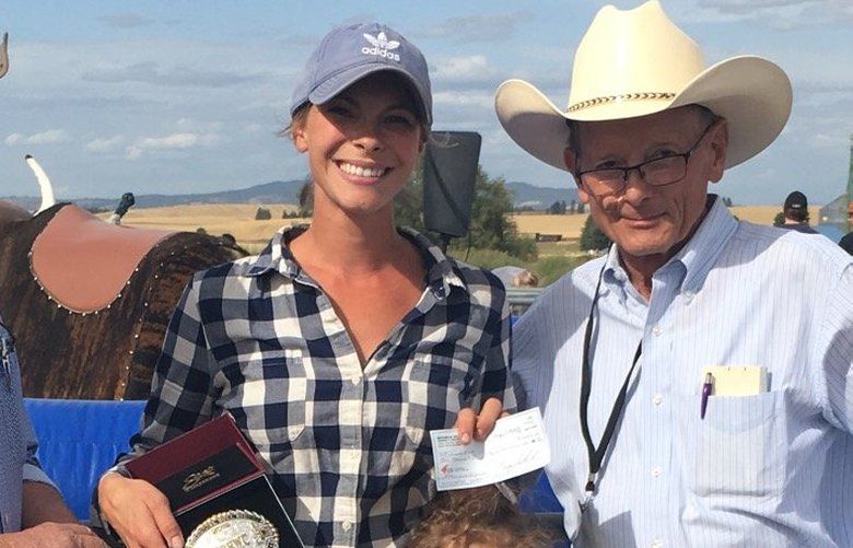 Laura Moore (center), an equestrian coach at Washington State University, recently won what was described as the world championships of mechanical bull riding in Spangle, Washington.