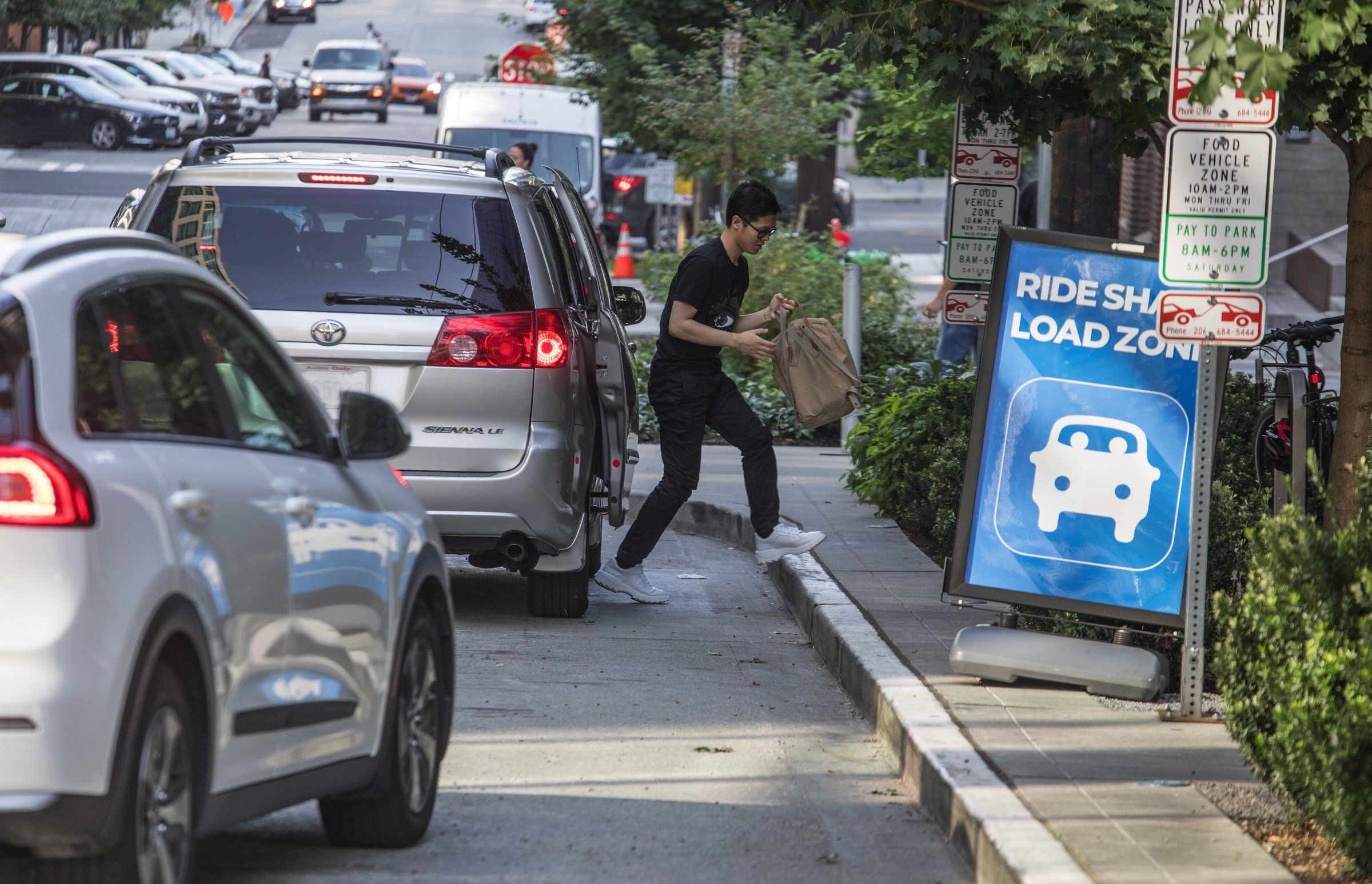 Seattle Uber and Lyft drivers often stop in the street to pick up