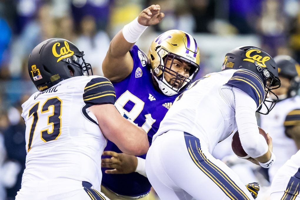 Huskies defensive lineman Tuli Letuligasenoa sacks Golden Bears quarterback Chase Garbers as the University of Washington Huskies take on the California Golden Bears at Husky Stadium in Seattle Saturday September 7, 2019. (Mike Siegel / The Seattle Times)