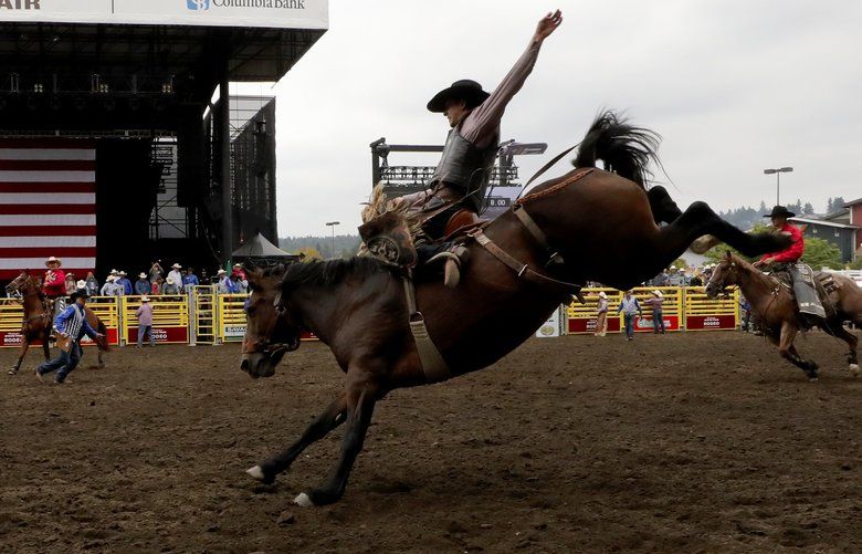 Scenes from the rodeo: Cowboys put their skills to the test in Puyallup