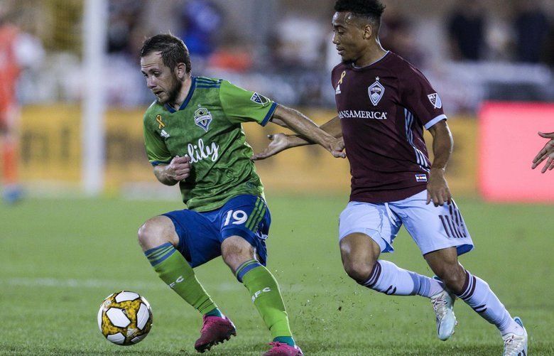 Seattle Sounders forward Harrison Shipp (19) dribbles the ball away from Colorado Rapids forward Jonathan Lewis (11) during the first half of an MLS soccer match Saturday, Sept. 7, 2019, in Commerce City, Colo. (AP Photo/Joe Mahoney) COJM104 COJM104