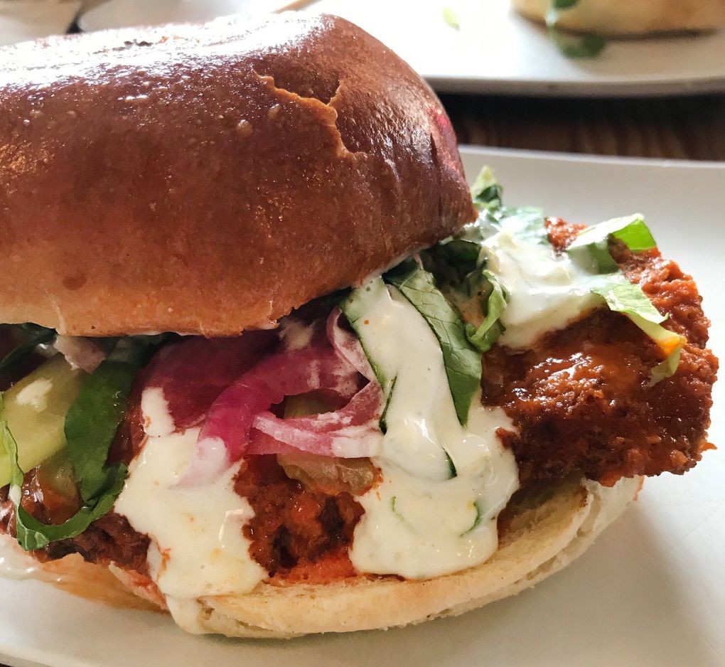 Uneeda Burger’s homage to the Buffalo wing includes a katsu-style chicken dressed up with celery, blue cheese and ranch dressing, but what makes this sandwich sing is the Frank’s hot sauce doctored with butter and Champagne vinegar. (Tan Vinh / The Seattle Times)