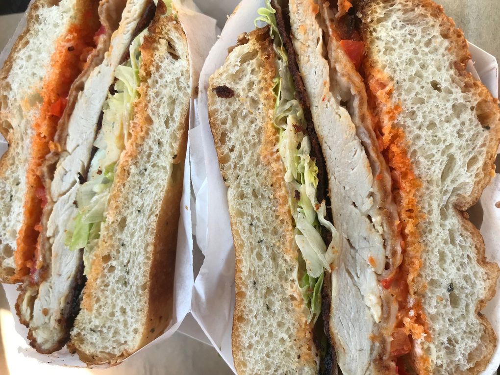 Mean Sandwich’s version has melted provolone atop a breaded cutlet with a creamy-tart zing of pickled red bell peppers, Hellmann’s mayo and Frank’s hot sauce. (Tan Vinh / The Seattle Times)