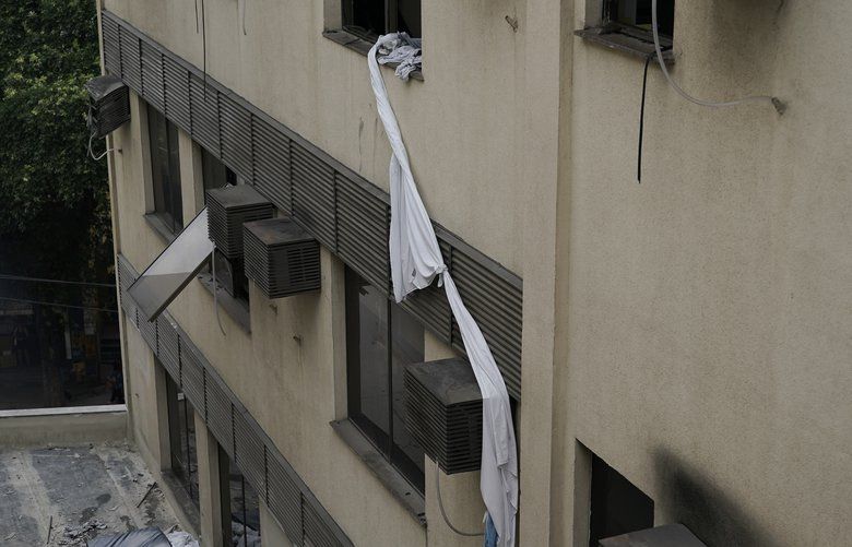 A rope made of bedsheets that was used to escape from the upper floor of the Badim Hospital, is seen tied to a window, where a fire left at least 11 people dead, in Rio de Janeiro, Brazil, Friday, Sept. 13, 2019. The fire raced through the hospital forcing staff to wheel patients into the streets on beds or in wheelchairs. (AP Photo/Leo Correa) XLC105 XLC105