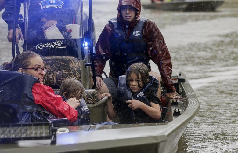 First responders with the Harris County Sheriff’s Office, Texas Game Warden, and Huffman Fire Department rescued people from flooded homes in the Lochshire neighborhood Friday, Sept. 20, 2019, in Huffman, Texas. Emergency workers used boats Friday to rescue about 60 residents of a Houston-area community still trapped in their homes by floodwaters following one of the wettest tropical cyclones in U.S. history. (Godofredo A. VÃ(degrees)squez/Houston Chronicle via AP) TXHOU107 TXHOU107