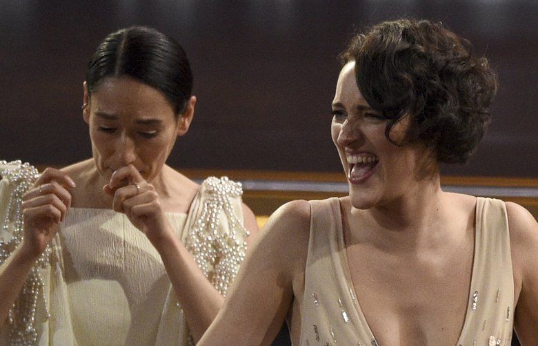 Sian Clifford, left, and Phoebe Waller-Bridge react before going on stage to accept the award for outstanding comedy series for “Fleabag” at the 71st Primetime Emmy Awards on Sunday, Sept. 22, 2019, at the Microsoft Theater in Los Angeles. (Photo by Chris Pizzello/Invision/AP) CADC434 CADC434