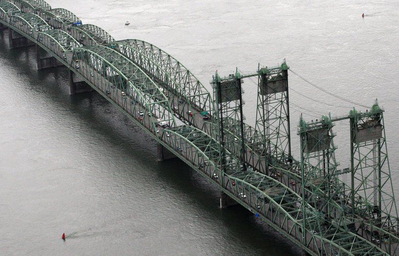 This June 29, 2012, photo shows the Interstate 5 bridge spanning the Columbia River between Oregon and Washington states, near Vancouver, Wash. Columbia River Crossing planners have been sued over the proposed 95-foot height of a new Interstate 5 bridge between Vancouver and Portland.  (AP Photo/Rick Bowmer)
