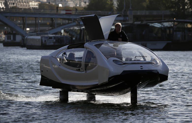 SeaBubbles co-founder Sweden’s Anders Bringdal stands onboard a SeaBubble on the river Seine, Wednesday Sept. 18, 2019 in Paris. Paris is testing out a new form of travel – an eco-friendly bubble-shaped taxi that zips along the water, capable of whisking passengers up and down the Seine River. Dubbed Seabubbles, the vehicle is still in early stages, but proponents see it as a new model for the fast-changing landscape of urban mobility. (AP Photo/Francois Mori) PAR104 PAR104