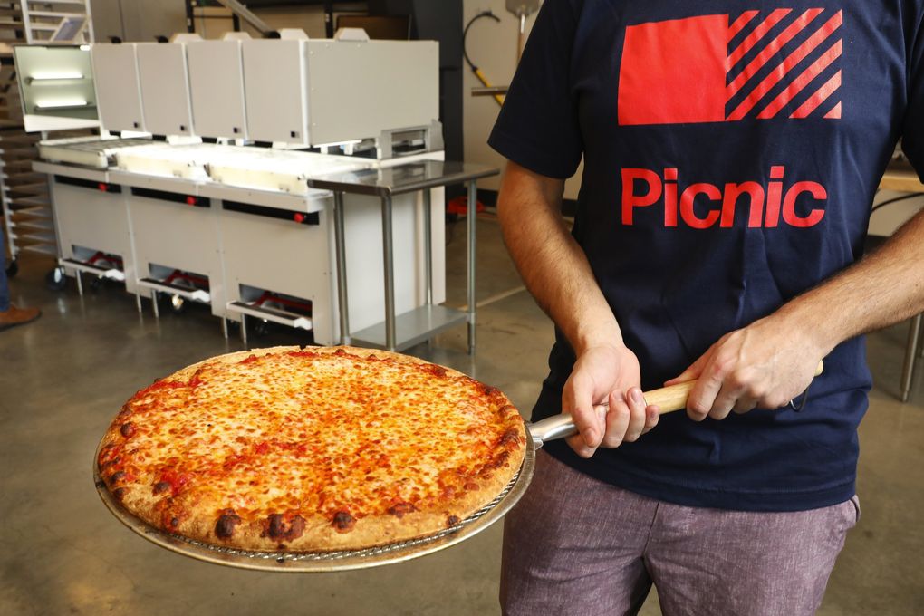 A finished cheese pizza is ready to eat during a demonstration at Seattle-based Picnic. (Ken Lambert / The Seattle Times)