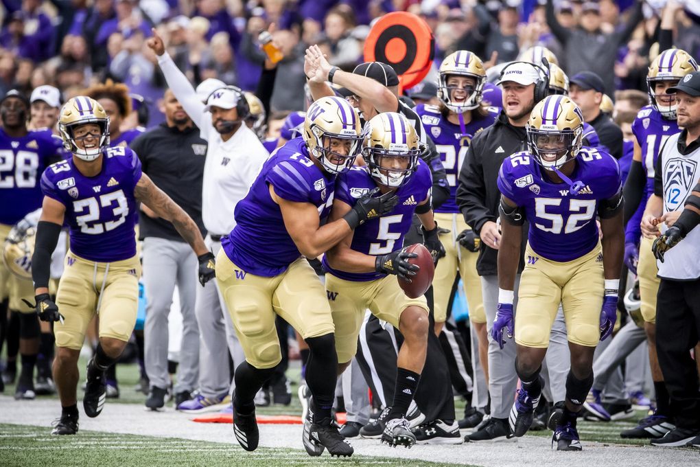 Washington linebacker Brandon Wellington, left, celebrates with defensive back Myles Bryant after Bryant’s first-quarter interception as the University of Washington Huskies take on the Hawaii Rainbow Warriors at Husky Stadium in Seattle Saturday September 14, 2019. 211495 (Mike Siegel / The Seattle Times)