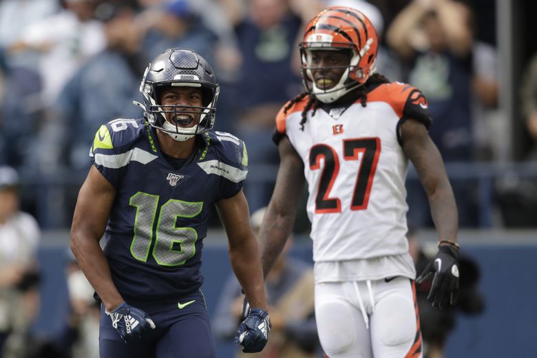 Wide receiver Tyler Lockett of the Seattle Seahawks smiles between