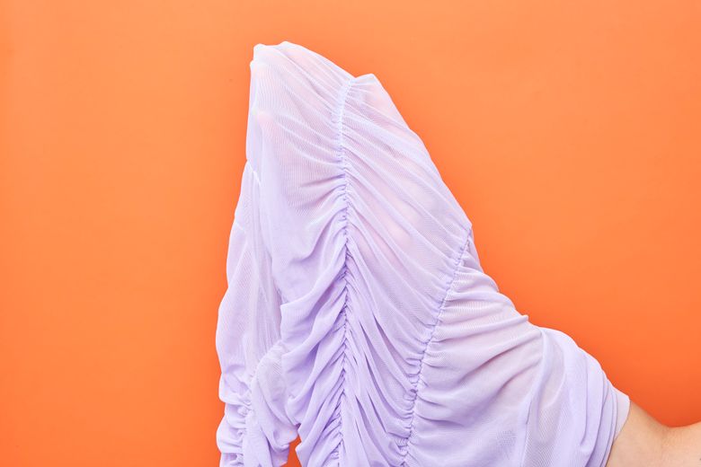 When shopping, test the thickness of a fabric by looking for your hand through it. The environmental impact of our clothing choices extends far beyond our closets and buying fewer items that are more durable can lower the impact on the planet. (Jessica Pettway/The New York Times)