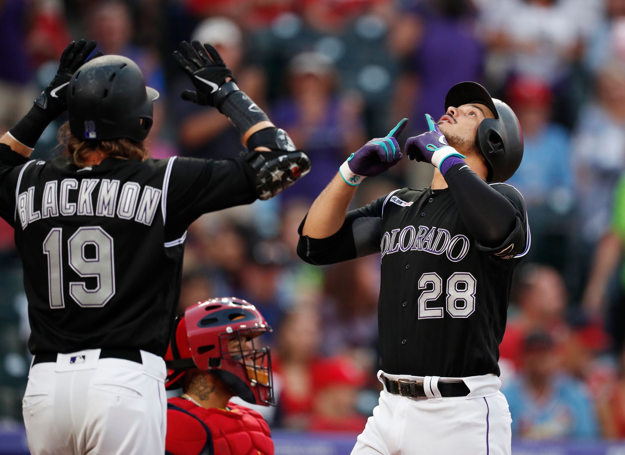 Colorado Rockies' Carlos Gonzalez is congratulated by teammates