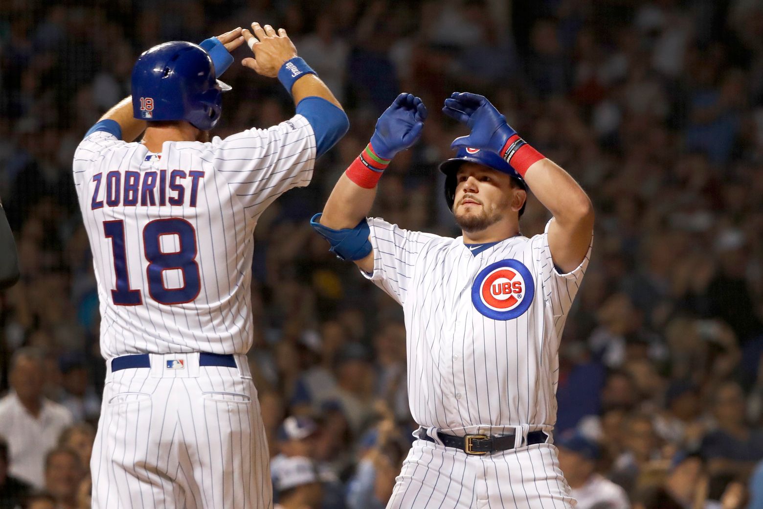 Cincinnati Reds' Derek Dietrich, right, celebrates with Kyle