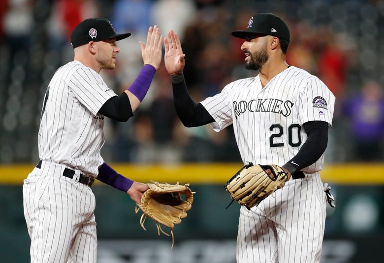 Colorado Rockies Tony Wolters (14) scores on RBI-double hit by