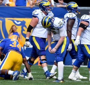 Pitt quarterback Kenny Pickett watches his team take on Delaware from the  sideline in the quarter of an NCAA college football game Saturday, Sept. 28  2019, at Heinz Field in Pittsburgh. (Matt